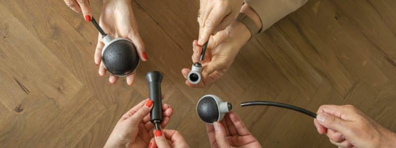 Vibra behandelkoppen worden vastgehouden door handen van professionals
